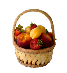 Wicker basket full of fresh ripe fruits: peaches, apricots and strawberry isolated on white.