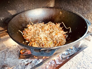 noodles are fried in a pan