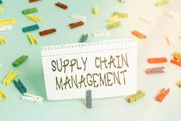 Writing note showing Supply Chain Management. Business concept for Aspects of modern smart company logistics processes Colored clothespin papers empty reminder blue floor officepin