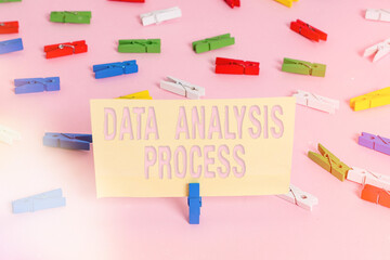 Conceptual hand writing showing Data Analysis Process. Concept meaning build a dashboard and analyze with graphs and visualization Colored clothespin papers empty reminder pink floor office