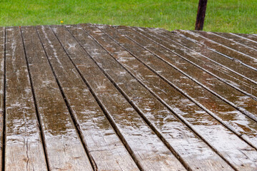 Rain falling on wooden terrace