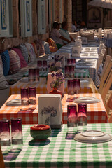 empty seats waiting for the customers in Izmir, Alacati district. Alcohol glasses are on the table already. Summer dinner concept. food tourism in turkey.