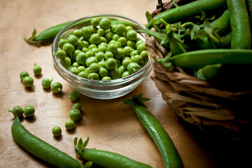 ripe green peas on a wooden table