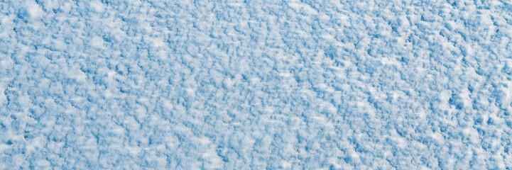 Natural snow texture. The surface of clean fresh snow. Snowy ground. Winter background with snow patterns. Perfect for Christmas and New Year design. Closeup top view.