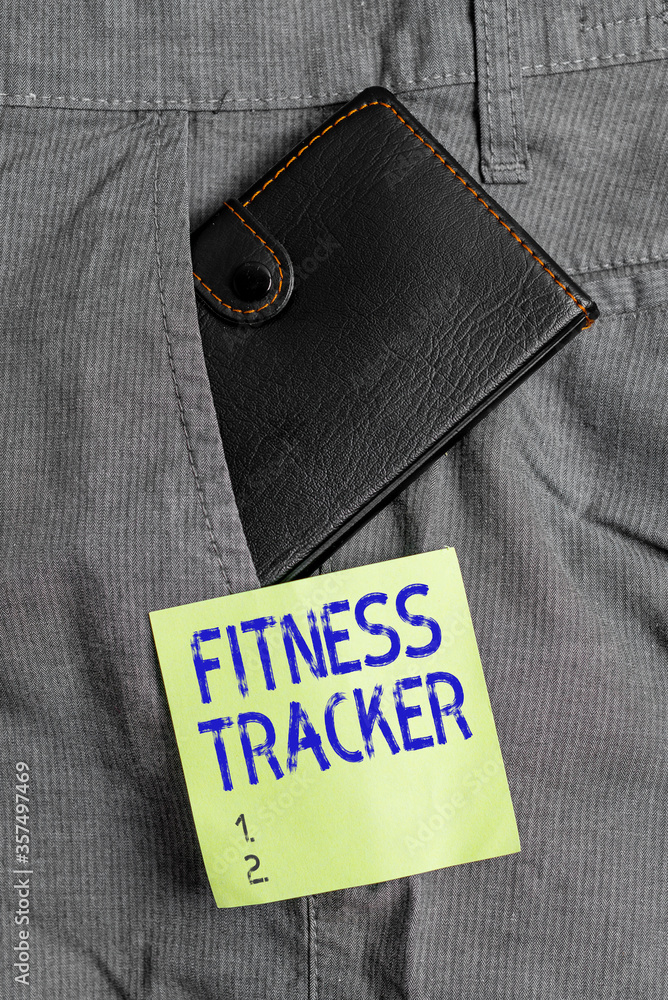 Poster Writing note showing Fitness Tracker. Business concept for a monitoring device that records any healthrelated activity Small wallet inside trouser front pocket near notation paper