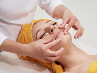 Face massage procedure. Skincare, rejuvenation, antiage wellness therapy. Doctor cosmetologist, dermatologist in job