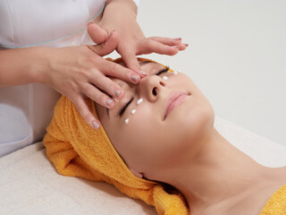 Face massage procedure. Skincare, rejuvenation, antiage wellness therapy. Doctor cosmetologist in job