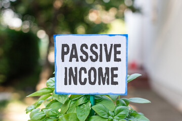 Writing note showing Passive Income. Business concept for earnings extracted from rental property,...