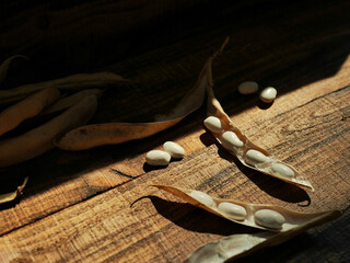 white kidney beans on wooden background. Dried organic harvest of white beans
