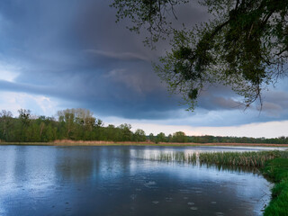 Heavy Stormy sky clouds over the river. Ominous dramatic sky lanscape view