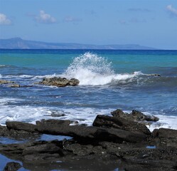 Waves break on rocks