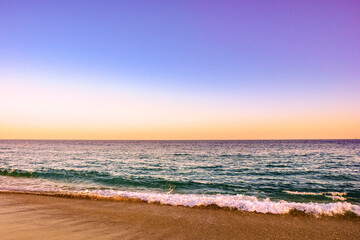 Fototapeta na wymiar Waves Crashing on the Beach in Cabo at Sunset