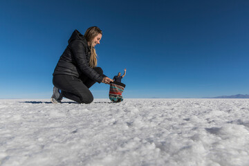 Couple playing with perspective in desert salt flats