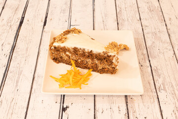 Portion of carrot cake on wooden table
