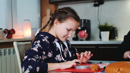 Cheerful young girl filling baking dish with pastry dough. Family traditions concept.
