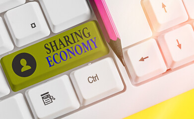 Writing note showing Sharing Economy. Business concept for a system where assets are shared...
