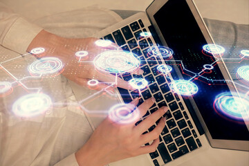 Double exposure of woman hands working on computer and social network theme hologram drawing. Top View. People connection concept.