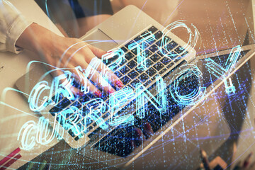 Double exposure of woman hands typing on computer and crypto market theme hologram drawing....
