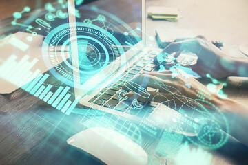 Double exposure of woman hands typing on computer and business theme hologram drawing. Success concept.