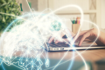 Double exposure of woman hands typing on computer and business theme hologram drawing. Success concept.