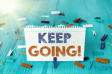Writing note showing Keep Going. Business concept for to continue living normally despite the...