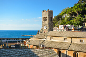Fototapeta premium The blue Ligurian sea and coast from the town of Monterosso al Mare, on the Italian Riviera of Cinque Terre Italy with the church tower in view