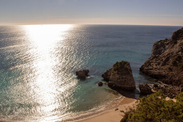 Praia Ribeira do Cavalo, a hidden beach of crystal clear blue waters near the town of Sesimbra, Portugal