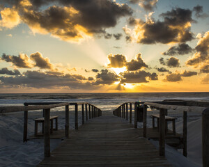 Sunset through the clouds in New coast beach ,Aveiro , Portugal