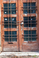 Old painted wooden door with chain and padlock, old town, Crakow, Poland.