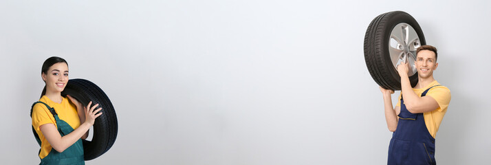 Sellers with car tires on light background, space for text. Banner design © New Africa