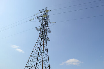 Metal support of a high-voltage power line against the blue sky.