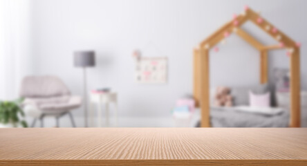 Empty wooden table in baby room interior