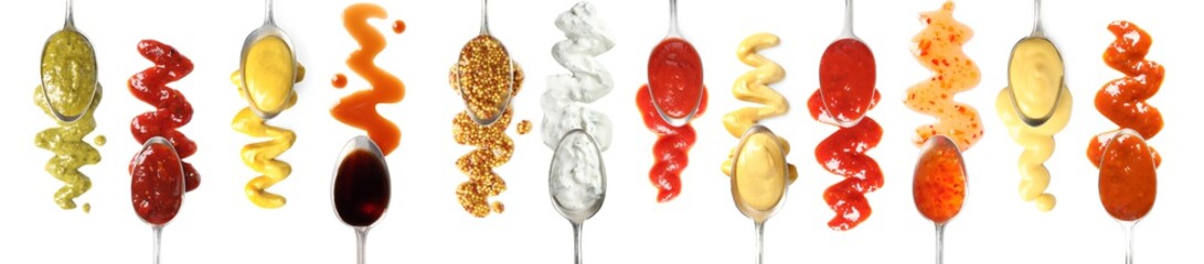 Set of spoons with different delicious sauces on white background, top view. Banner design