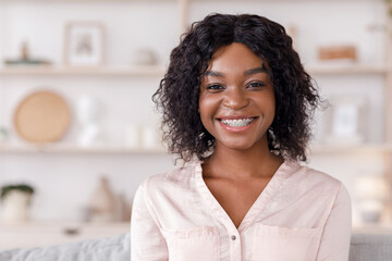 Teeth Alignment. Portrait Of Black Girl With Dental Brackets Posing At Home