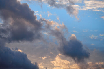 Fototapeta na wymiar Stormy and ordinary clouds in the blue sky.