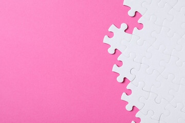 Blank white puzzle pieces on pink background, flat lay. Space for text