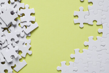 Blank white puzzle pieces on yellow background, flat lay