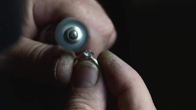 Jeweler polishing wedding ring by polishing motors tools, 4k macro footage