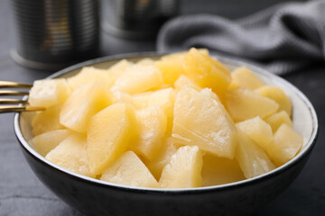 Pieces of delicious canned pineapple in bowl, closeup