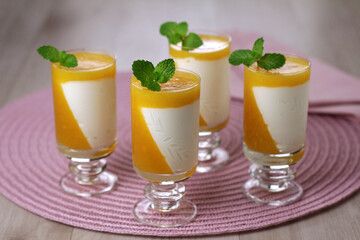 lemon mousse dessert with passion fruit gelatin and mint leaf