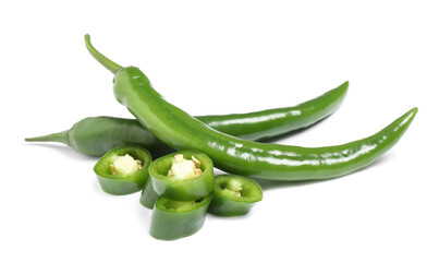 Cut and whole green hot chili peppers on white background