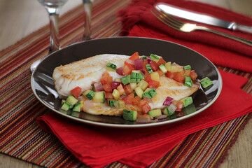 fish fillet with grilled vegetables - zucchini, tomatoes, red onion