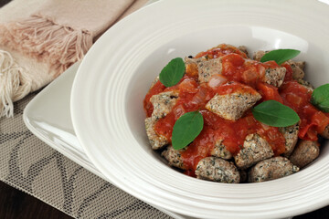 spinach gnocchi with tomatoes sauce and basil