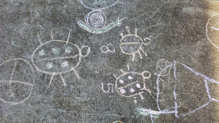 Fototapeta na wymiar Children chalk paintings on the pave way in kindergarten