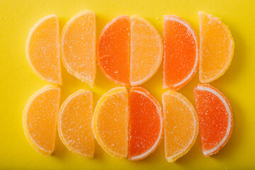 Multi-colored marmalade jelly candy's. Dessert marmalade in the form of lemon and orange slices. The sweetness of jelly candy yellow and orange. Top view