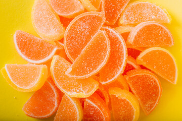 Macro photo multi-colored marmalade jelly candy's. Dessert marmalade in the form of lemon and orange slices. The sweetness of jelly candy yellow and orange. Copy space