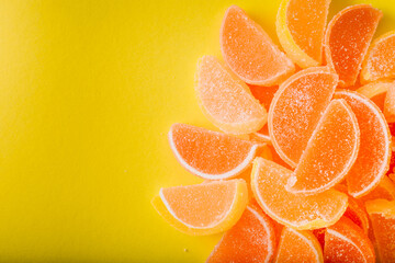 Macro photo multi-colored marmalade jelly candy's. Dessert marmalade in the form of lemon and orange slices. The sweetness of jelly candy yellow and orange. Copy space