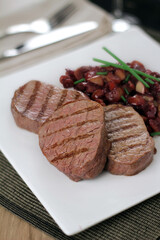meat medallions in wine and pine nut sauce