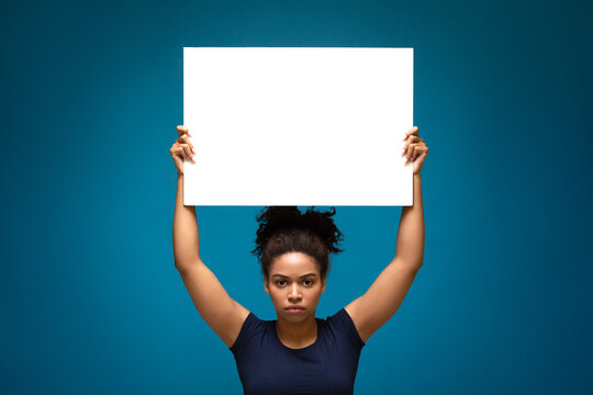African american woman protesting with blank placard,