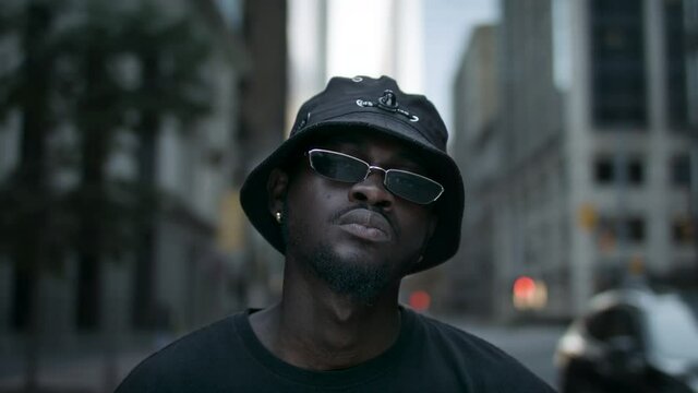 Stylish portrait of a cool African American man in a downtown city centre. Shot in 4k